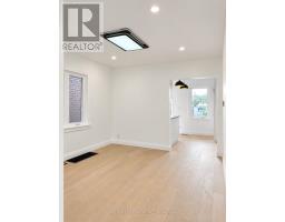 Renovated basement room with recessed lighting and wood-look floor - 54 Thyra Avenue Toronto