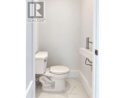 Dark vanity, white sink, toilet, bathtub, and tiled walls - 54 Thyra Avenue Toronto