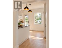 Hallway with glass-paneled door and runner rug - 54 Thyra Avenue Toronto