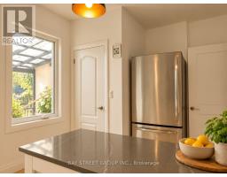 Home office with wooden desk, chair, bookshelf, and striped blinds - 54 Thyra Avenue Toronto