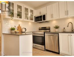 Living room with hardwood floors, double doors, and roller blinds - 54 Thyra Avenue Toronto