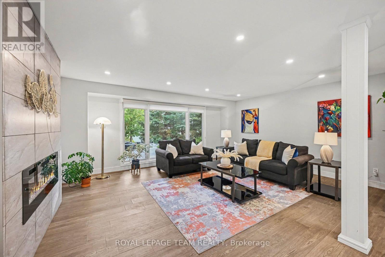 Open concept living room with electric fireplace.