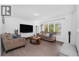 Family room - 4044 Windsong Boulevard Sw, Airdrie, AB T4B3Z5 Photo 9