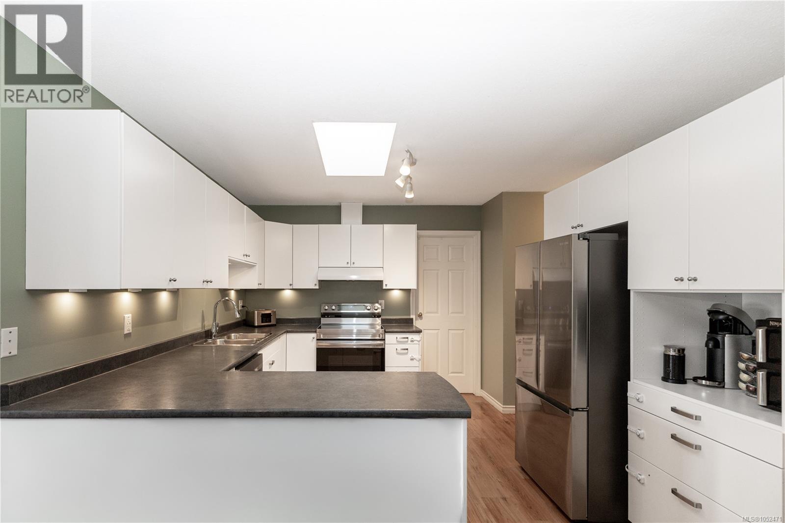 Sky light in the kitchen and stainless appliances, eat up bar as well