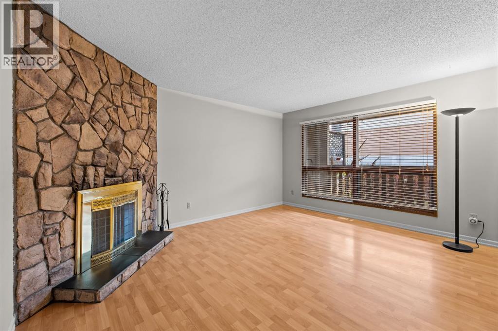 A floor to ceiling stone fireplace gives the living room its character