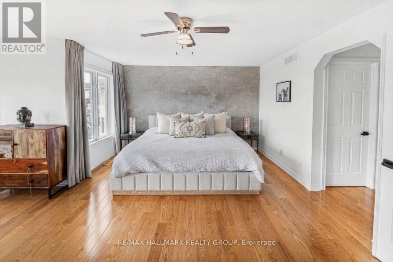 Primary Bedroom with Hardwood Floors and En-Suite