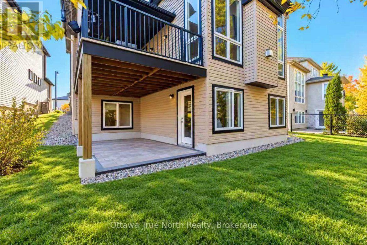 Walk out basement with 3 tall windows and patio.