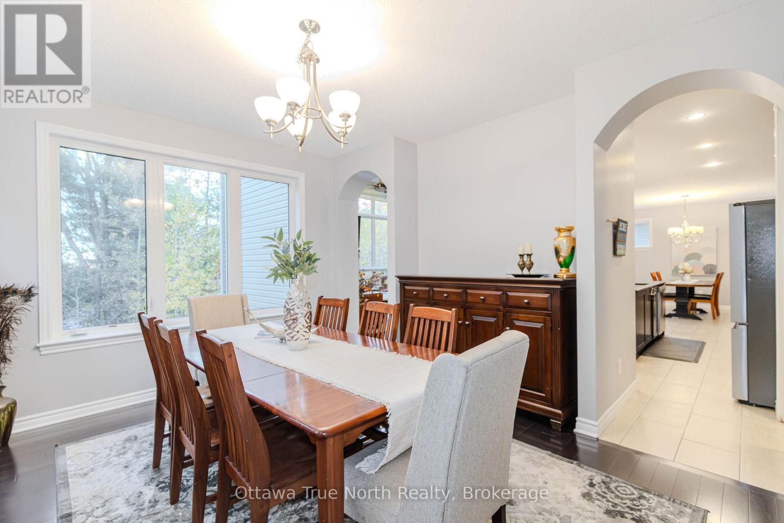 Formal dining room framed by 2 graceful archways