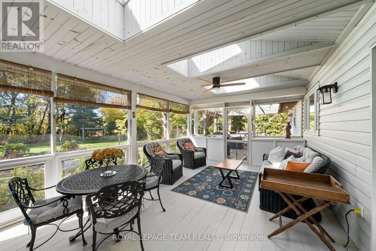Enclosed Porch off the Kitchen Leading to Deck