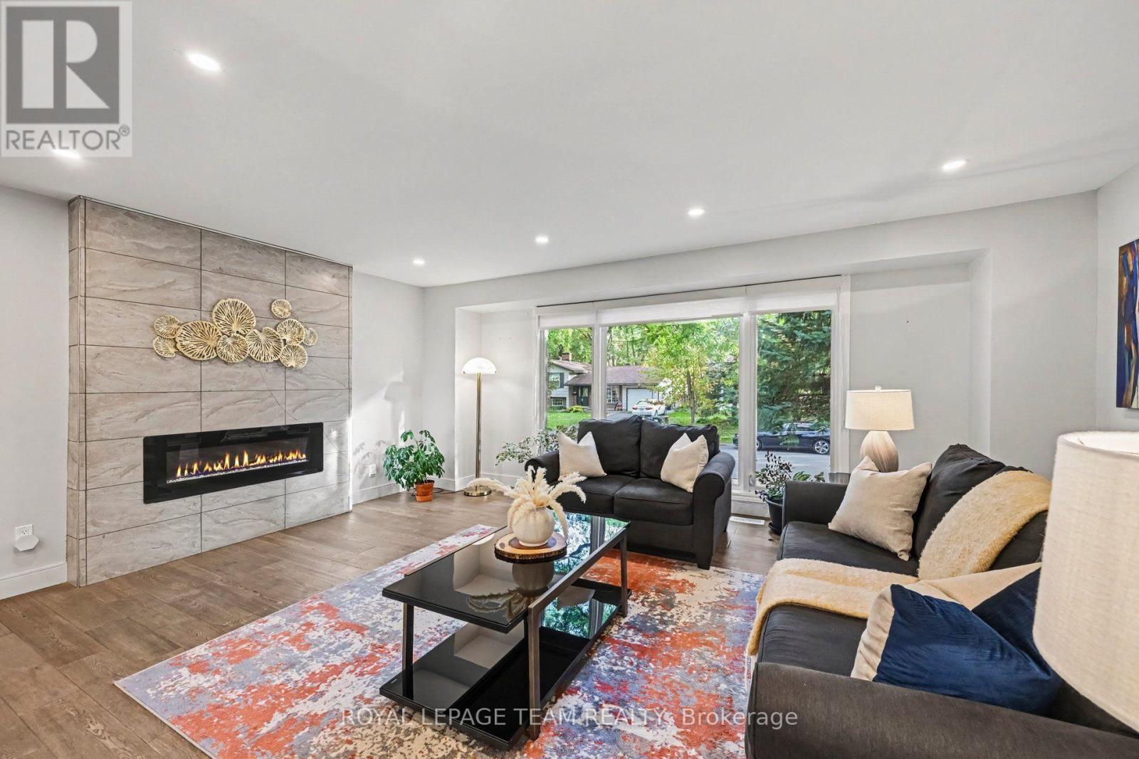 Open concept living room with electric fireplace.