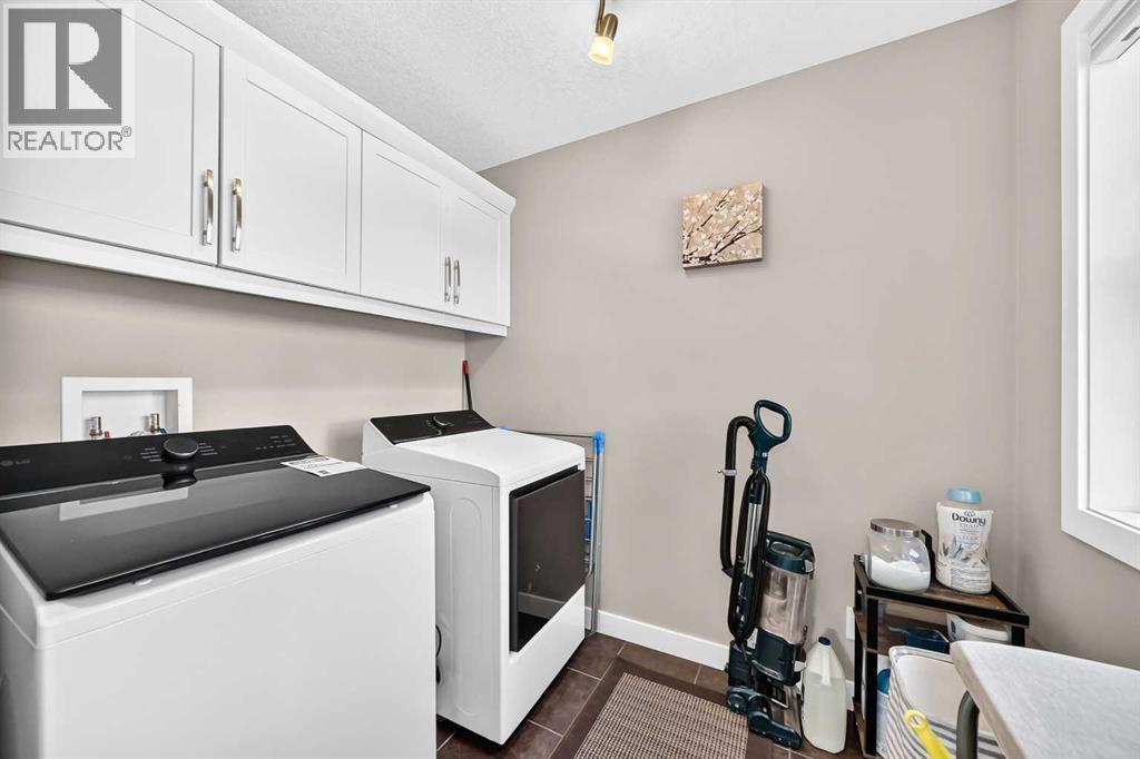 Upper Floor Laundry With Cabinet Storage
