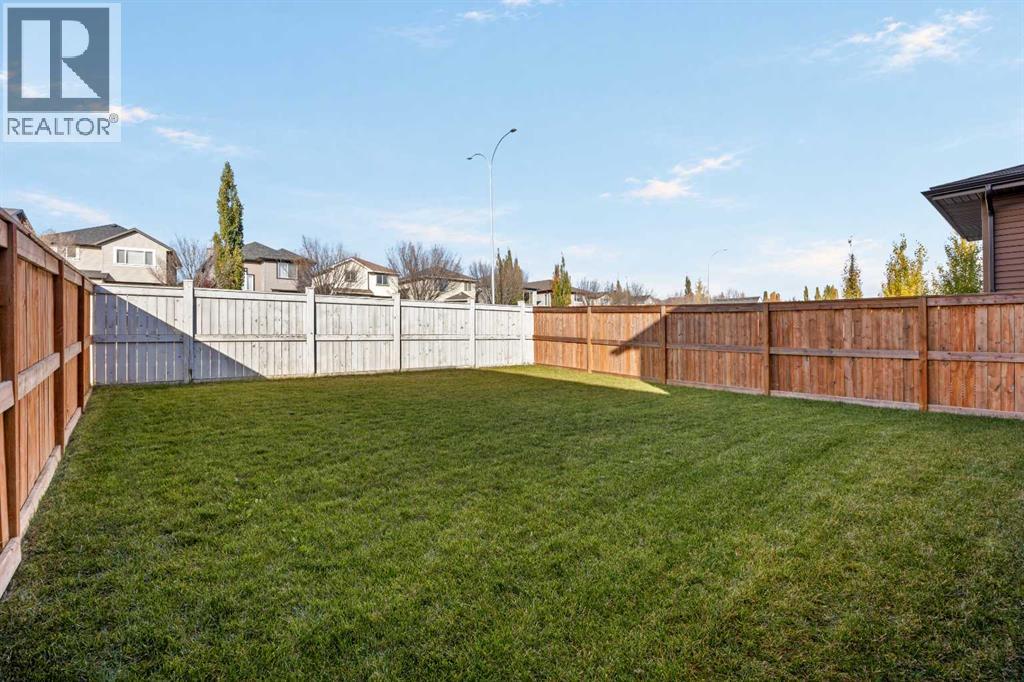 The yard is substantially larger than many interior lots on the street, with no neighbours directly behind and room for kids to play
