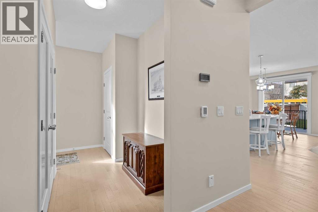 The office is tucked just off the front entry, with a frosted glass door and a window that keeps it bright and private