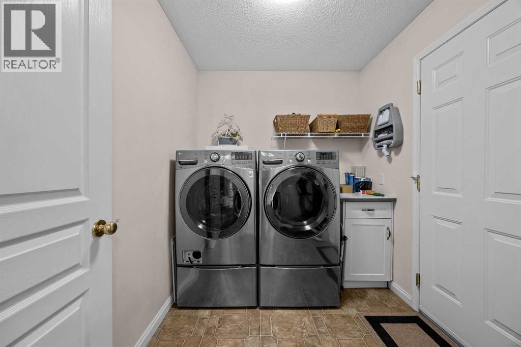 No more carrying laundry up and down the stairs! A dedicated main-floor laundry room with front-loading appliances, additional cabinetry, and storage makes everyday chores that much simpler