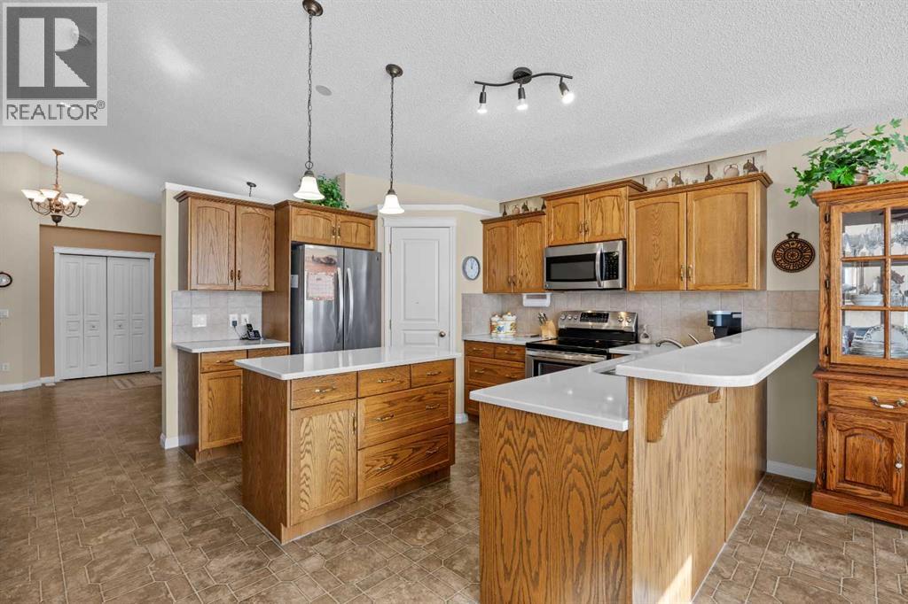 Thoughtfully arranged for everyday living, the kitchen features a central island, ample cabinetry, and a dedicated pantry, with an easy connection to the rest of the main floor