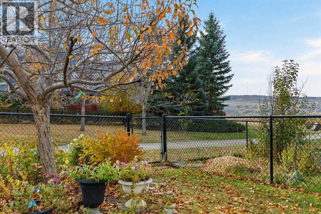 A garden gate that leads straight to the pathway, with rolling hills on the horizon