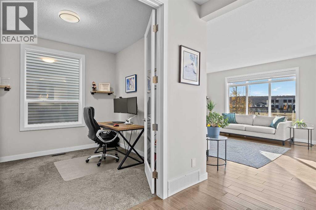 Just off the main living area, a dedicated office with French doors offers a quiet place to work from home without feeling disconnected from the household