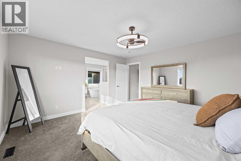 Generously proportioned with room for substantial furnishings, this comfortable primary suite offers a quiet escape at the end of a busy day
