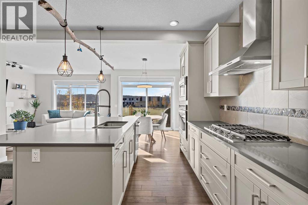 With an upgraded gas cooktop, built-in wall oven, and premium stainless steel appliances, this kitchen is wonderfully equipped for those who love to cook