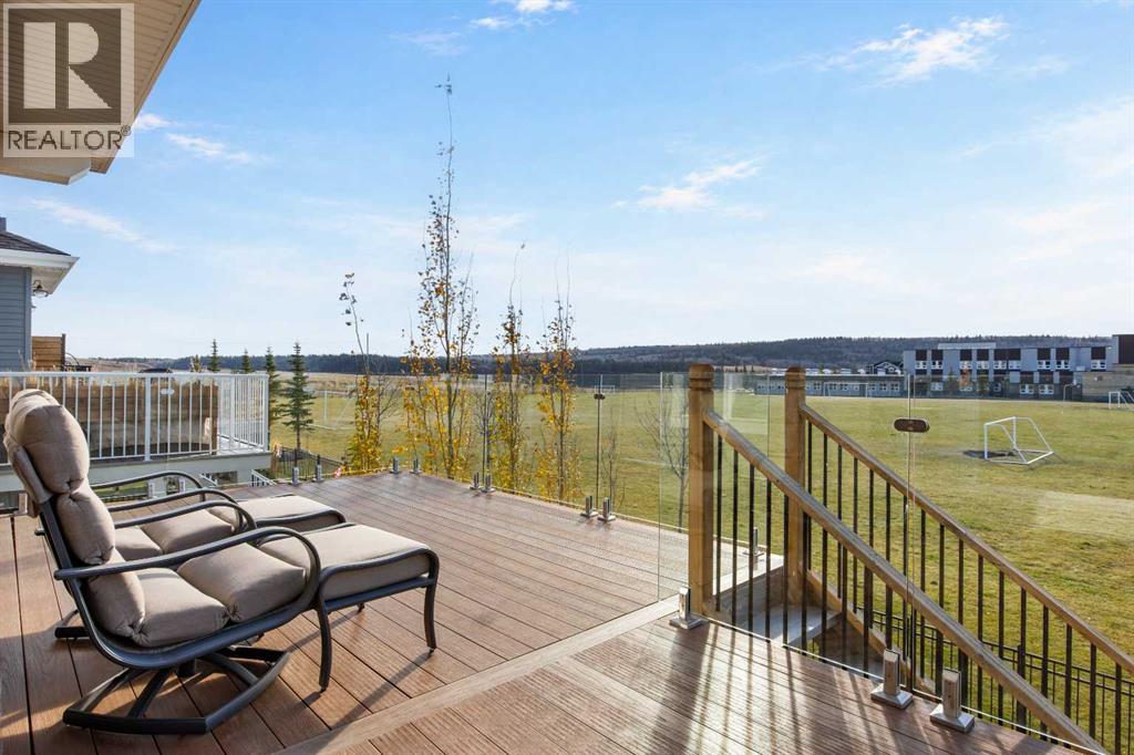Glass railings preserve the expansive outlook, while the generous deck offers plenty of room to relax, entertain, and enjoy the outdoors