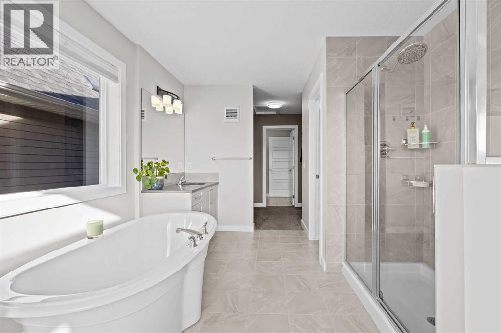 A little everyday luxury, with a spacious glass-enclosed shower and freestanding bathtub offering the perfect place to unwind