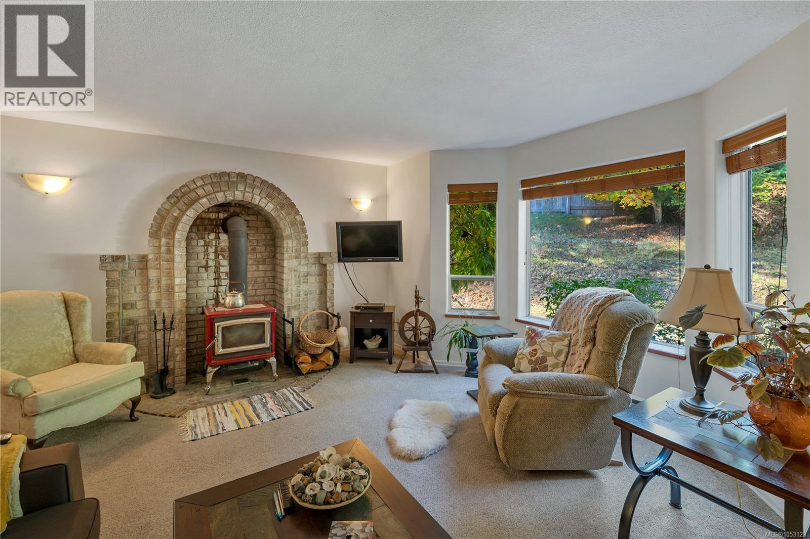 the home offers a main level entry with upper floor layout, here is the living room on the main floor