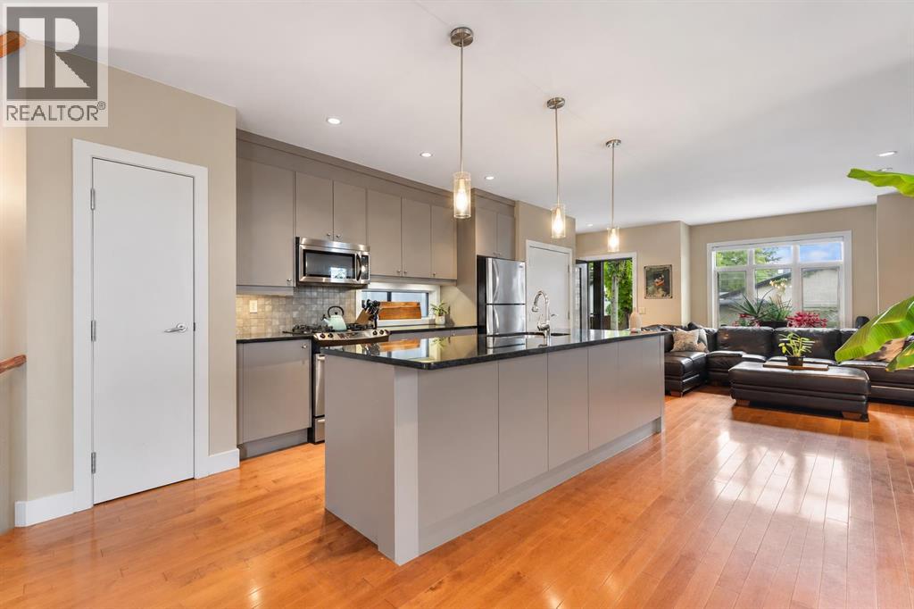 The spacious kitchen features granite counters, stainless steel appliances