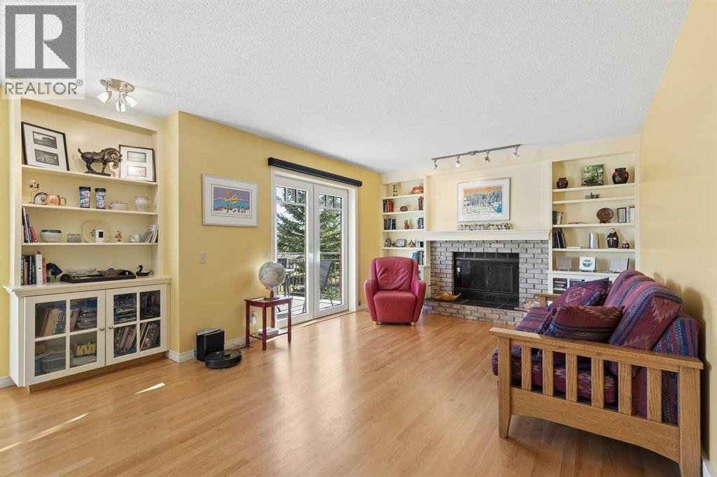 The family room features a wood-burning fireplace with gas starter and hardwood flooring, as well as patio doors that lead to the back deck