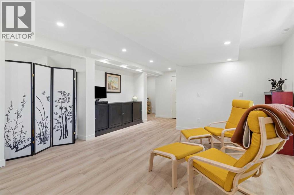 Large basement recreation room with luxury vinyl plank flooring