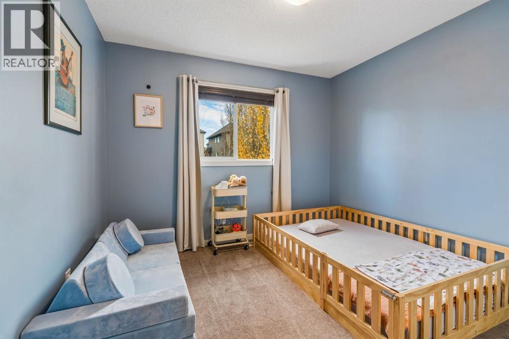A charming secondary bedroom with soft blue tones, natural light & a cozy atmosphere, ideal for creating a peaceful retreat