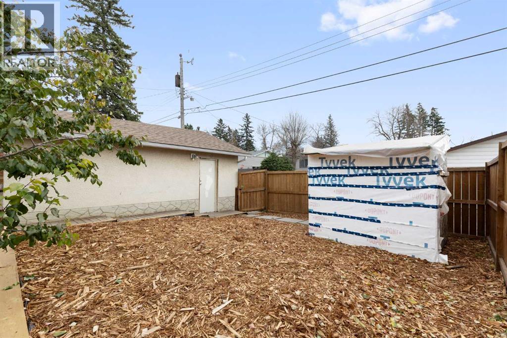 The yard features garden beds, a prolific apricot tree and a good-sized garden shed under construction