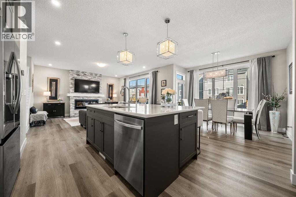 Bright main floor connecting the kitchen, dining area, and living room with upgraded finishes