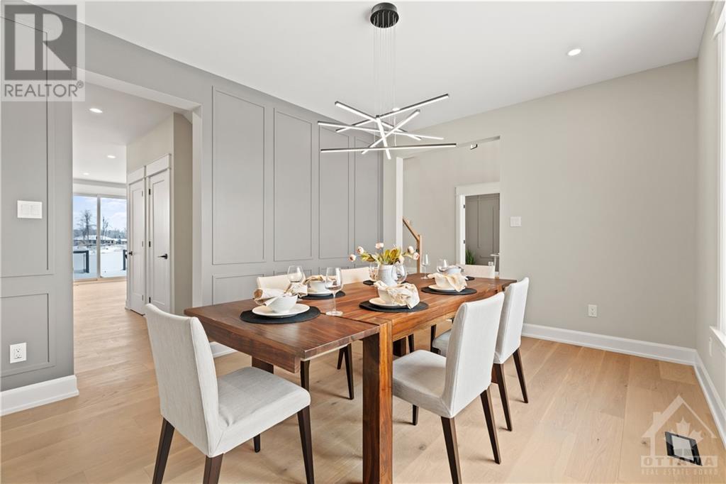 a spacious dining room with eye-catching feature wall offers ample space to host