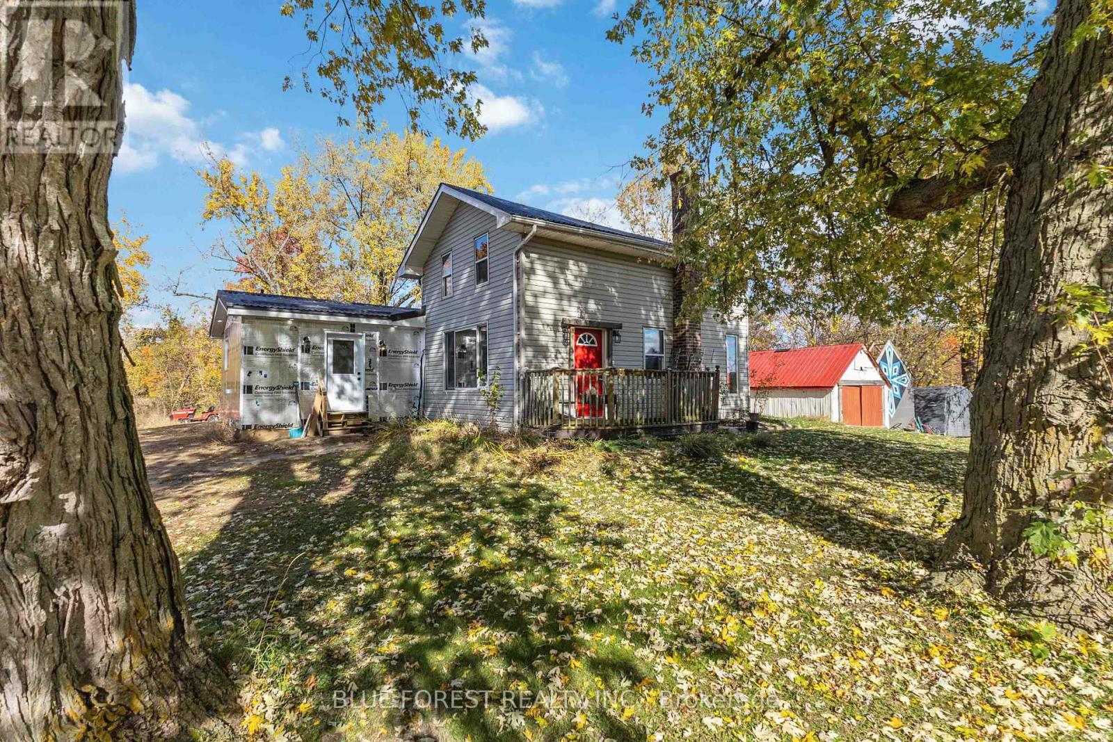 Discover the perfect blend of tranquillity and opportunity with this picturesque 12-acre property, offering 8 workable acres, two serene ponds, and a flowing, spring-fed creek. Surrounded by mature trees and a peaceful wooded area, this idyllic slice of nature promises privacy, beauty, and the chance to create your dream estate. The property boasts a unique setup, including a recent addition, perfect for a rental unit or an extension of the main home. With two kitchens and a functional separation via the laundry room, you'll have flexibility whether you're thinking of multigenerational living or generating rental income. The addition features a spacious bedroom with a cheater ensuite and a generous living area while the main home offers two cozy bedrooms in the upper half-storey. This property is ideal for anyone looking to finish the addition to their own taste or even build a future custom estate home, as seen across the street, but with the benefit of extra acreage. Practical amenities include a single detached garage with hydro, ample parking space, and breathtaking views. Whether you're dreaming of farming, outdoor hobbies, or simply enjoying the serene setting, this property offers endless potential. Embrace the lifestyle you've been craving - rural charm just moments from town conveniences. (id:48254)