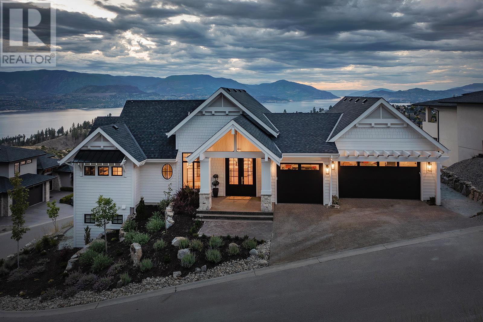 5670 Mountainside Court Kelowna, British Columbia Quietly perched at the top of Kettle Valley, this standout modern farmhouse is high on style and low on maintenance, with the added benefit of spectacular lake and city views. With 5 bedrooms, 4 bathrooms, and 3965 sqft of custom designed space, every inch of this home is built for comfort, function, and making the most of family time. The interior design perfectly blends modern farmhouse charm with luxury finishes, featuring custom beams, shiplap accents, and detailed millwork throughout. The kitchen, dining and living rooms, and upper deck take full advantage of the lake views. Cooking in the custom kitchen is a joy, with honed quartz counters, Viking appliances, and a perfectly-placed French door double oven. The spacious primary wing feels like your own private retreat, offering a large bedroom, a spa-inspired ensuite, a massive walk-in closet, and a private office. The lower level is designed with entertaining and overnight guests in mind. Three generous bedrooms (including one with built-in bunkbeds), two bathrooms, and a large rec room create a welcoming space for everyone, while the passthrough window from the bar to the pool makes entertaining a breeze. The UV pool and expansive pool deck provide more room to play. This is the ultimate Kettle Valley home, offering a rare combination of luxury, location, and practicality. With plenty of room for your family and friends to visit, everyone is able to relax and enjoy the best of Kelowna living year-round. (id:48254)