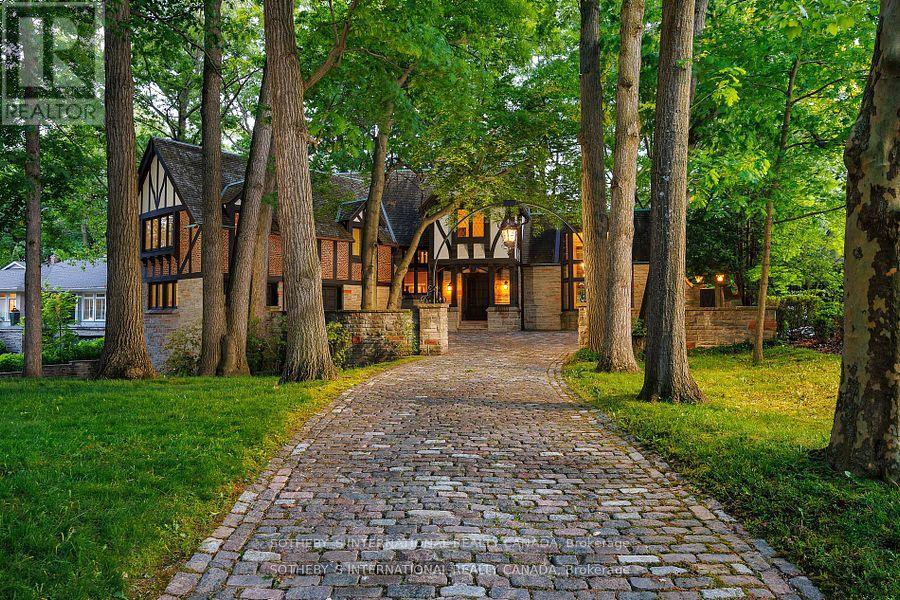 Step into elegance and history with this majestic Tudor estate, a unique gem backing onto St. George's Golf & Country Club, this rare find offers unparalleled charm and potential. This generational home is a testament to its enduring style and craftsmanship. Its timeless appeal and meticulous maintenance ensure it stands ready for your personal touch. From the original checkerboard tile floors to beamed ceilings and four masonry fireplaces, this home radiates timeless appeal. For those looking to make this exquisite home their own, the potential for modern customization is boundless. Imagine adding a new upper-floor bathroom, dual floating wine rack walls, or modern finishes that blend seamlessly with the home's original character. This charming estate, owned by a single family since its construction, features formal principal rooms, four masonry fireplaces, structural beamed ceilings, and dual cobblestone driveways. With parking for eight cars in the garage, multiple stone terraces, a cedar roof, and a stone-walled cobblestone courtyard, this property is designed to impress. Meticulously maintained, the estate boasts commercial-grade construction and offers level tableland at the rear, perfect for enjoying as-is or expanding as desired. Architecturally significant, this home was designed and built specifically for its unique site, commanding attention with its bespoke design and presence. This estate is more than a home; it's a legacy. Located in the prestigious Edenbridge-Humber Valley, it offers a unique lifestyle opportunity. the neighborhood is celebrated for its beautiful homes, lush greenery, and an atmosphere of close-knit community. It combines serene, upscale living with effortless access to the vibrant energy of Toronto. Enriched by excellent schools, charming shops, and convenient highways offering a harmonious blend of tranquility and urban sophistication. (id:48254)