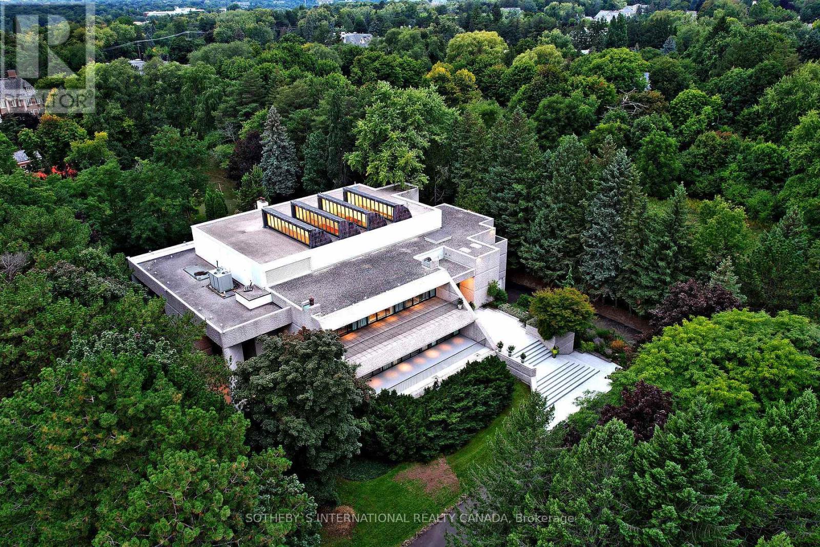 30 High Point Road Toronto (Bridle Path-Sunnybrook-York Mills), Ontario An exceptionally rare landmark residence in Toronto's most prestigious neighbourhood. Discreetly hidden behind lush landscaping & on the quietest section of the Bridle Path. The internationally renowned architect John C Parkin successfully implemented his modern vision into this mid-century masterpiece. Parkin's forward thinking brought to life these unique attributes:(1) integrated a beautiful concrete building into the 2.12-acre landscape, with less traffic & more privacy (2) flooded the spaces in natural sunlight thanks to the central 4-storey solarium with massive skylights & enormous windows & private indoor & outdoor pools (3) subtlety united 2 ground-level drive-through indoor-garage facilities, and additional surface parking lot through circular driveway direct to grand landing. (4) created opulent spaces & casual intimate areas. Host a sizeable charitable event, with 26,000 sqft of space across all levels plus enormous open space at 3.5 storey atrium, you can easily accommodate large gatherings. Have a live band at the base of the atrium or spend intimate time in the zen meditation garden **EXTRAS** You will appreciate meticulous plans at every aspect of this modern wellness design. A statement for your family name stamp. A phenomenal estate to add to your life's most valuable collections. (id:48254)