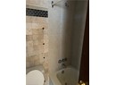 Bathroom featuring toilet and tiled shower / bath