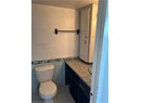 Bathroom with tile patterned floors, vanity, tile walls, and toilet