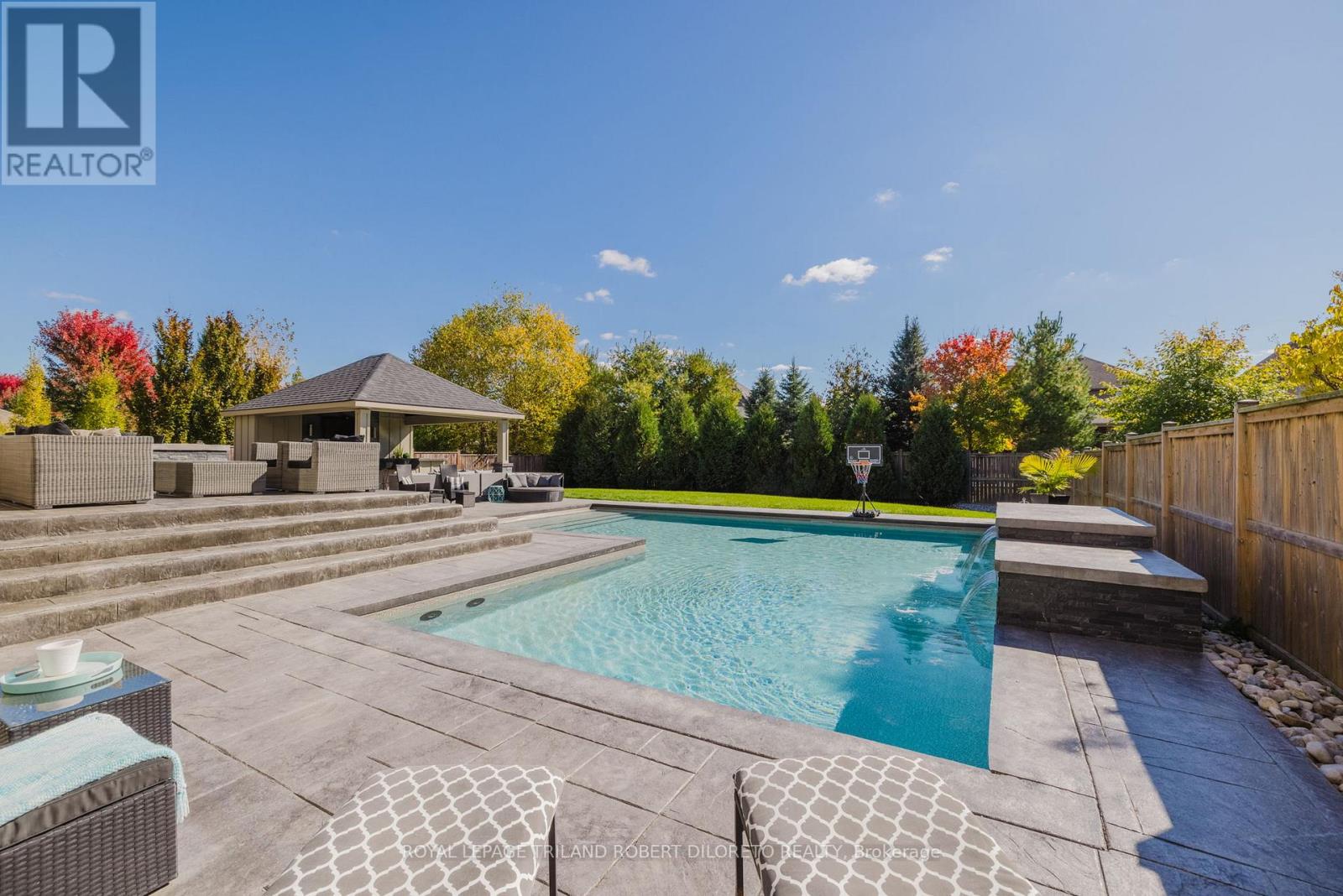 Timeless Elegance & Quality Customization throughout this incredible 4BRM, 3.5BA executive 2-storey w/Triple garage and jaw dropping "staycation" exterior all on huge lot in established neighbourhood of Kilworth! Why bother building new when you can have it all without all the hassle of new builds & dust! Custom built by the current owner with careful attention to every minute detail. This incomparable home features: attractive grand curb appeal w/stone & stucco exterior front elevation, soaring front entry & stamped concrete triple drive; totally "wow" filled first impression interior boasts high ceilings w/custom treatments & crown moulding, hardwood floors, oversized windows & modern neutral decor; entertain guests in style in the beautiful dining room w/coffered ceiling; main floor office w/tiered tray ceiling; light filled open concept main living areas feature 2-storey great room w/wall of south facing windows & fireplace flanked by custom book cases & cabinets; gorgeous designer kitchen boasts ample custom cabinets, quartz counters, quality appliances (incl. 6 burner gas range), island + coffee bar peninsula both w/seating; family sized contemporary mudroom w/built-ins & separate laundry w/washer, dryer + convenient walkout to rear yard; the upper level features 4 oversized bedrooms all w/ensuite privileges & is highlighted by a sumptuous primary bedroom w/luxurious 5pc ensuite w/heated floor & 2 walk-in closets; the finished open concept lower boasts massive recreation area w/gas fireplace flanked by custom built-ins, gym area, storage & rough in bath.  New owners & guests will never want to leave the amazing private yard w/its expansive stamped concrete covered patio, open patio & gas fireplace, heated saltwater pool w/water feature & incredible entertainment sized cabana w/grilling area kitchen, bar & 2pc bath! The list goes on! This home must be seen in person to fully appreciate the amenities, style, quality & location! (id:48254)