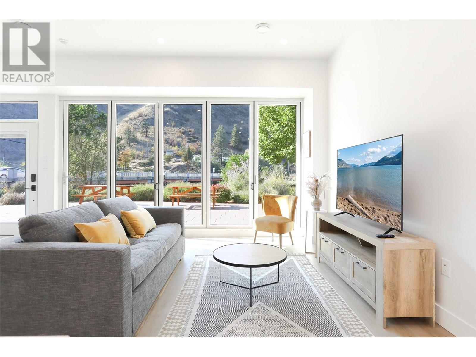 Welcome to this stunning turn key corner-unit 1-bedroom condo that can be sold fully furnished. As you step inside, you'll be captivated by the abundance of natural light streaming through the expansive 16ft window doors that fold open, seamlessly connecting the indoors with the outdoors. This gem of a property faces the lake and not only boasts picturesque views of the lake and the mountains but also has direct access to the KVR walking trail. Whether you're an avid swimmer, love kayaking, or simply enjoy peaceful strolls along the water's edge, this location is a dream come true. Inside, the condo features hot water on demand, a highefficiency heat pump, smart appliances, and concrete walls and ceilings with extra insulation for privacy and efficiency. The well-appointed bedroom provides ample space for restful nights and boasts a walk-in closet. The bathroom is stylishly designed and offers modern fixtures and floor-to-ceiling tiles. Don't miss this incredible opportunity to purchase this property. In both unit 105 and 106 there is an optional door for access to either unit or lockable from both sides for security and privacy. This can be removed if purchased separately. Units 102, 103 are also available. GST applicable. (id:48254)