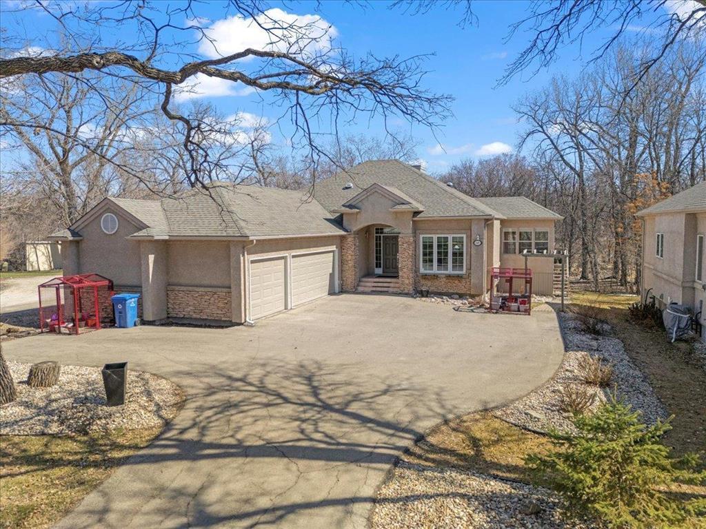 645 St Anne's Road Winnipeg, Manitoba 2E//Winnipeg/S/S: Now. Offers: May 6th. Enjoy the rare luxury of peaceful, country-style living in this 1,871 sqft custom built bungalow by Parkhill Homes-perfectly situated on a private, treed lot backing onto the Seine River. Upon arrival, you are welcomed by picturesque landscaping and paved driveway that leads to a three-car garage with add'l parking pad. Prepare to be amazed as you walk into the open concept main floor with huge windows that let nature flow right in! HWF's flow throughout the main level, featuring a formal DR & Great Room with vaulted ceilings & gas FP. The gourmet kitchen boasts granite, new S/S appliances and large island-ideal for everyday living & entertaining. The 3-season sunroom and deck offer stunning views of the river and surrounding greenspace. Large primary BR with deluxe ensuite, 2nd BR and laundry/mudroom complete the main floor living space. The fully finished lower level includes a bright Rec Room with full-size windows and gas FP, a spacious BR with WIC, 4 piece bath and huge Den/Gym with French doors. Add'l upgrades: structural wood floor, tri-pane windows & shingles. This exceptional home combines the tranquility of nature with the convenience of city living! A must see! (id:48254)