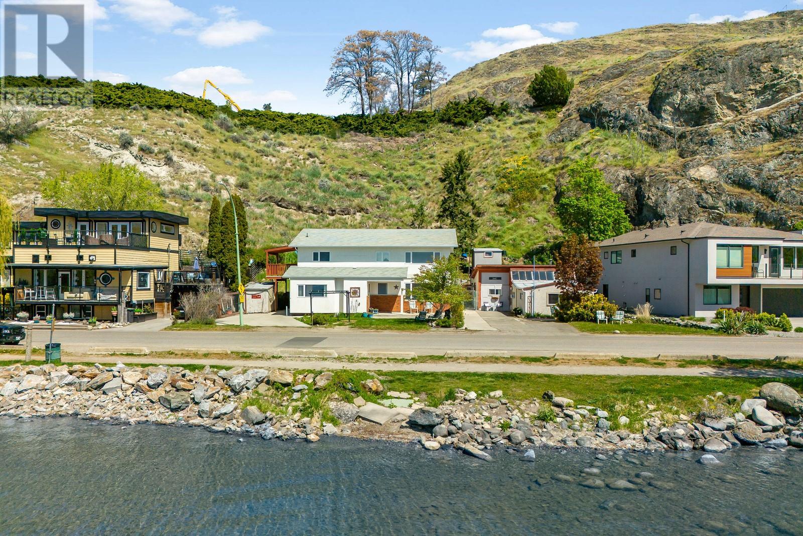 457 Poplar Point Drive Kelowna, British Columbia Step into one of the most versatile and valuable properties in Kelowna—semi-lakefront, three income-generating suites, and mere steps from Knox Mountain's trails and downtown charm. Whether you're an investor seeking smart returns, a family craving flexible space, or dreaming of a vacation home with a serious upside, this one checks every box (and then some). Inside the 2,700 sq ft home, enjoy four bedrooms, four bathrooms, and sweeping views of the lake right across the street. The main home is bright and welcoming, with peaceful water views from the kitchen and living room—a daily reminder you’ve made it. Two separate suites, including a guest house, offer excellent mortgage relief or multi-generational living potential. And yes, paddle boarding before morning coffee is an actual possibility here. With Knox Mountain hiking out your back door, and Kelowna’s best restaurants, shops, and cafes just a short stroll away, this location blends nature and city life like few others can. Properties like this don’t come around often. (id:48254)