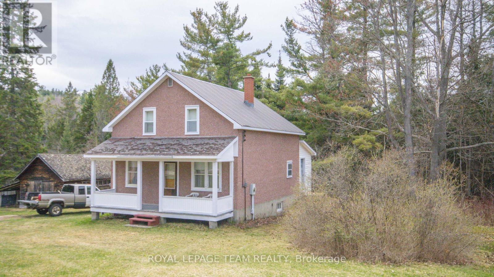 Country living at its best. Newly severed 12 acre lot in the historic Wilno area. This charming country home is full of character and features 4 large bedrooms on the upper floor, an oversized country kitchen and a large mudroom. There is a large covered porch at the front of the home to sit and relax and enjoy the country air. The home is heated with a combination wood/electric forced air furnace.  The basement has a walkout to the side yard. The property has a number of outbuildings, is well treed and very private. The home is serviced with a drilled well (165 feet deep) and septic, 200 amp electrical service with a newer breaker panel. This area is famous for its snowmobile and ATV trails. The area is also surrounded by a large number of lakes which are excellent for swimming, fishing and boating. The property is being sold as is where is with no representations or warranties. (id:48254)