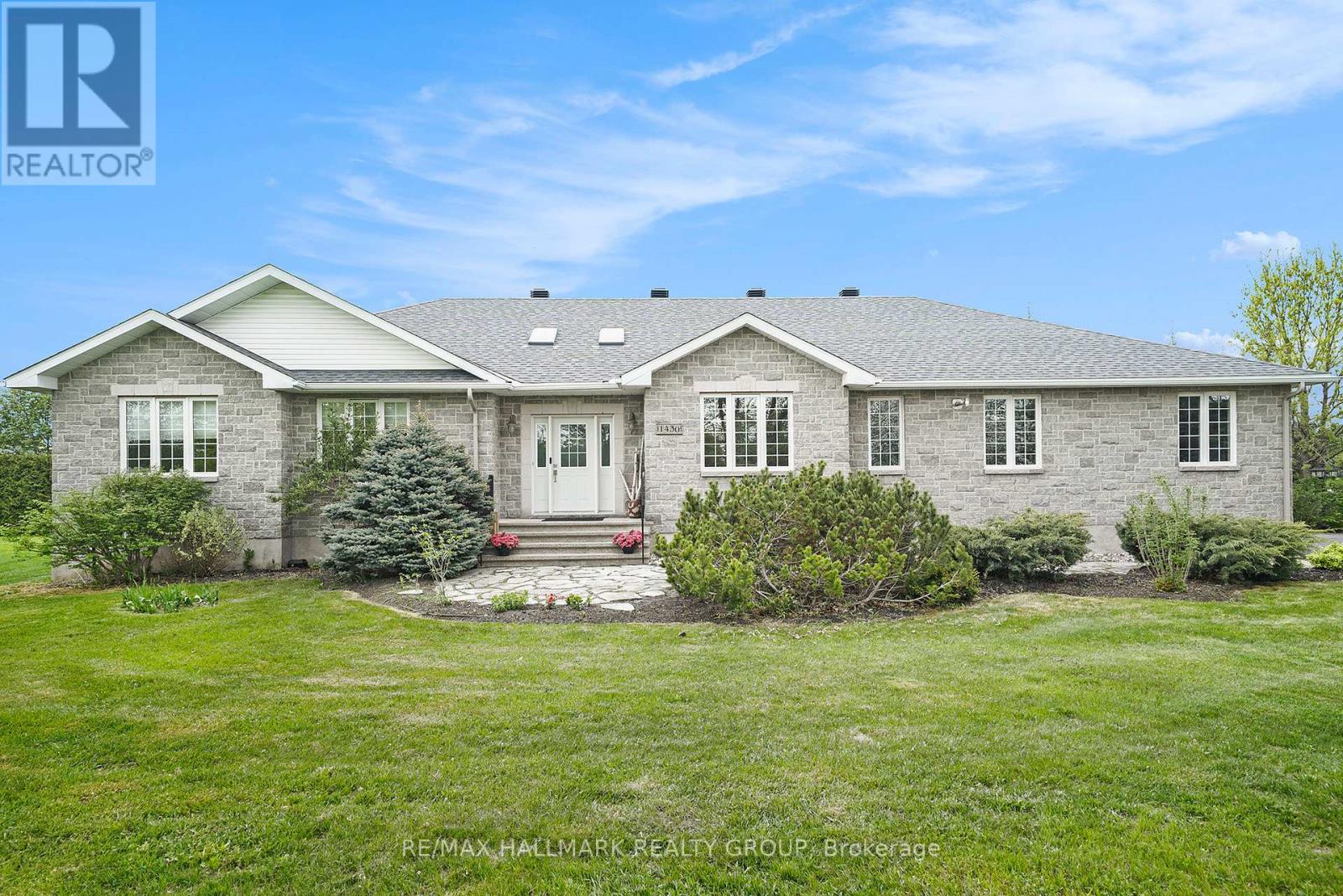 1430 Spartan Grove Street Ottawa, Ontario Welcome to this custom-built stone bungalow, a true gem nestled in a serene setting with accessory apartment income potential. As you step inside, you'll be greeted by soaring cathedral ceilings and a spacious living room with a cozy wood-burning fireplace, perfect for relaxing evenings. This home features a formal dining area for family meals and gatherings, along with an eat-in kitchen complete with all stainless steel appliances, ample cabinetry, a stylish ceramic backsplash, and a built-in desk nook. Step through the patio doors and enjoy your morning coffee on the deck overlooking a huge backyard, complete with a firepit for outdoor entertaining. A versatile den offers a quiet retreat or home office space, while inside access from the impressive 3-car garage, a private powder room, and a main floor laundry room add convenience and functionality. This 3-bedroom home includes a spacious primary bedroom with a generous walk-in closet and a luxurious 4-piece ensuite, featuring a corner soaker tub and a separate standing shower. The unfinished lower level presents endless possibilities for you to create your ideal space and has a fully roughed in in-law suite (SDU) ready to complete. Separate entrance as well as all plumbing and electrical work. Outside, you will find beautiful landscaping, charming stone walkways, and a treed lot that adds both privacy and a touch of nature to the property. New Furnace, AC, Air Exchanger and On Demand Water Installed in 2023. Heated garage and Irrigation system. This home combines comfort, style, and potential! Don't miss the chance to make it yours! (id:48254)