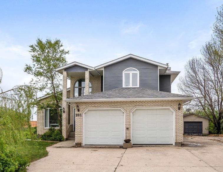 201 3rd Street North Niverville, Manitoba R07//Niverville/Offers as Receive. Huge Price Drop!!Nestled in the heart of Niverville, this well-loved 2,494 sq ft 2 story home offers comfort, space + endless potential. Owned by the same family for many years, it is ready for its next chapter. Set on a beautifully treed lot, the property features a double attached garage plus a detached single garage, perfect for extra storage, hobbies, or a workshop. Inside, the spacious layout includes 3 generously sized bedrooms, 3.5 bathrooms, and a bright main floor designed w/functionality in mind. You ll love the oversized sunroom that fills w/natural light, ideal for year-round relaxation or entertaining. The cozy ambiance continues w/2 fireplaces, adding warmth + charm to both the main living area + sunroom. Main floor laundry adds to the practicality of this home, while the fully finished basement offers even more living space, including a large rec room, full bathroom + potential guest area or home office. While the home may benefit from some cosmetic updates, its solid structure, thoughtful layout + unbeatable location makes it an incredible opportunity to create your dream home in a peaceful, close-knit community. Come see the potential this home has to offer! (id:48254)