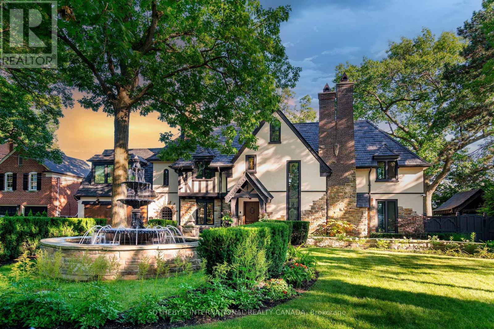 This stunning 1929 Tudor home has been meticulously transformed into a modern masterpiece, seamlessly blending historic charm with contemporary luxury and cutting-edge technology. Set on a sprawling 100' x 277' ravine lot, this $6 million renovation offers an exceptional living experience in one of Toronto's most prestigious neighborhoods. The grand exterior features a restored J.W. Fiske cast iron fountain and a heated cobblestone driveway, accommodating over 10 vehicles. Inside, every detail reflects craftsmanship and sophistication. The chef's kitchen, designed by Scavolini, is equipped with Wolf and Gaggenau appliances, while radiant-heated herringbone oak floors lead to floor-to-ceiling European folding glass doors that open to stunning ravine views. The spa-like bathrooms boast heated marble floors, European wall-mounted toilets, and custom millwork. Hidden HVAC systems, motorized blinds, and recessed lighting create a sleek, minimalist aesthetic. A state-of-the-art audio system, includes over 60 Bowers & Wilkins speakers, powered by Bryston, Sonos, and NAD amps. Four outdoor zones with buried subwoofers ensure exceptional sound across the property. The lower level is designed for entertainment, featuring 10' ceilings, polished concrete floors, a full-size arcade, a professional gym, and an indoor sauna. A walkout leads to a year-round heated pool, hot tub, and an all-season patio with infrared heaters, perfect for outdoor enjoyment in any weather. The home is fully equipped with app controlled automation for lighting, blinds, HVAC, security, audio, access, pool/spa/sauna. Residents enjoy access to the exclusive Baby Point Club, offering tennis, lawn bowling, and community events. A perfect blend of historic charm and modern luxury, this home offers an unmatched living experience. The home features a durable composite cedar roof with a lifespan of up to 60 years, offering long-lasting protection and timeless aesthetic appeal. (id:48254)