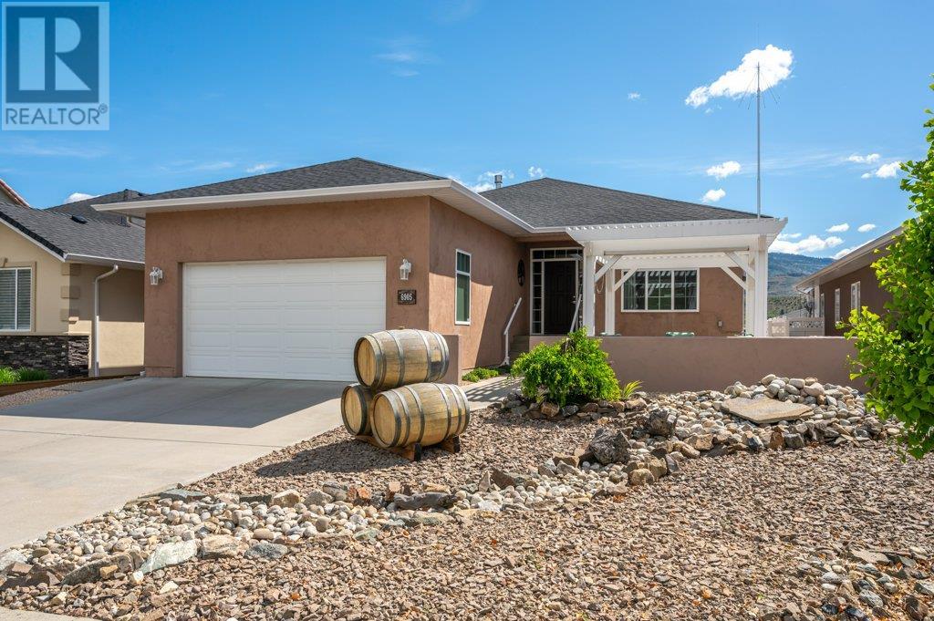 Welcome to this thoughtfully designed custom home featuring 3 bedrooms plus a den and a flexible layout with easy suite potential. The upper level offers tile flooring, a bright great room with a gas fireplace, and wall-to-wall windows that showcase beautiful views. The kitchen was updated in 2021 with a new induction range, quartz countertops, and stainless steel sinks. The primary suite includes a walk-in closet with custom organizers, a separate dressing area with washer and dryer, and a spa-like ensuite. Downstairs offers a bright and versatile space with exterior access—ideal for extended family or conversion into a 2-bedroom suite. Notable updates include a new roof (2016), hot water tank (2018), interior repaint (2020), kitchen upgrades and a new 8x12 insulated/wired shed (2021), and new sun deck stairs (2022). Located within walking distance to town and just 15 minutes to Osoyoos beaches and 20 minutes to Penticton (id:48254)