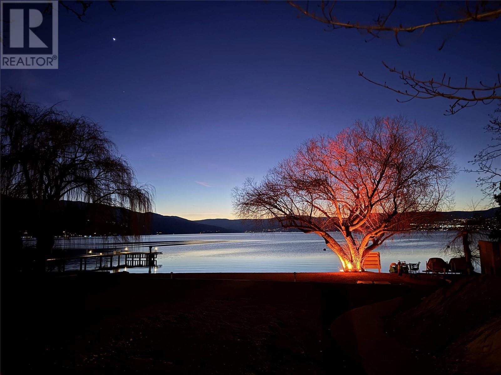 4614 Fuller Road Kelowna, British Columbia Discover an extraordinary chance to own a nearly one-acre waterfront property in Kelowna’s prestigious Lower Mission. Tucked away on a quiet stretch of shoreline, this remarkable home features approximately 100 feet of unobstructed lake frontage, offering panoramic views and a rare connection to the natural beauty of Okanagan Lake. The residence is thoughtfully positioned on a beautifully maintained lot, offering both privacy and sophistication. Inside, you’ll find a bright, open layout with expansive living spaces, and a gourmet kitchen that impresses with premium appliances and a custom oversized island designed for both function and style. The main bedroom suite includes direct access to the backyard and a spacious ensuite for ultimate comfort. Step outside to experience the seamless transition from indoor living to outdoor leisure, with a large patio ideal for hosting and a serene waterfront area perfect for quiet mornings or evening gatherings. The upper level media room adds versatility, making it easy to unwind regardless of the season. This property embodies the heart of Okanagan living—natural beauty, refined design, and a setting unlike any other. (id:48254)