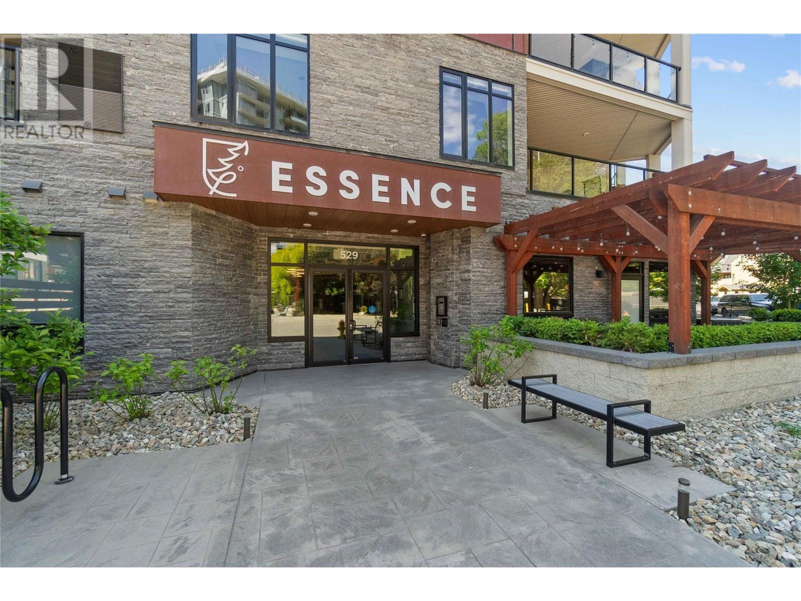 Welcome to this stunning 2,000 sq. ft. corner unit, perfectly situated just steps from Lake Okanagan in the vibrant Lower Mission. This single-level home offers the best of Okanagan living with thoughtful design &  high-end finishings. The open-concept living area is bright & inviting, framed by large windows that fill the space with natural light. The modern kitchen is a chef’s dream, featuring gas stove, premium appliances & a huge island that overlooks the living & dining spaces-perfect for entertaining or relaxing in style. With 2 large bedrooms, 2 full bathrooms & a versatile den, there's plenty of room. The primary suite is a true retreat, complete with a luxurious walk-in closet & spa-inspired 5-piece ensuite. Step outside to your private oasis - 500+ sq. ft. covered deck that expands your living space & invites you to enjoy Okanagan sunsets, summer dining, or simply lounging in comfort. This condo features in-floor heating, 9-foot ceilings & remote-controlled silhouette blinds. You’ll also appreciate the convenience of a same-floor storage unit and two parking stalls, including one in the heated parkade. This A+ boutique building offers lovely amenities: a fitness center, lounge with billiards, terrace with shuffleboard & bike storage. Steps from the Eldorado Resort, Aqua Boat Club, the upcoming waterfront boardwalk, Mission Park Greenway & Kelowna's newest waterfront park.  Don't miss out on this excellent opportunity to live in  Kelowna's most desirable area. (id:48254)